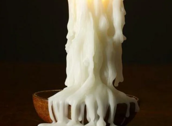 Artisan pouring beeswax candles